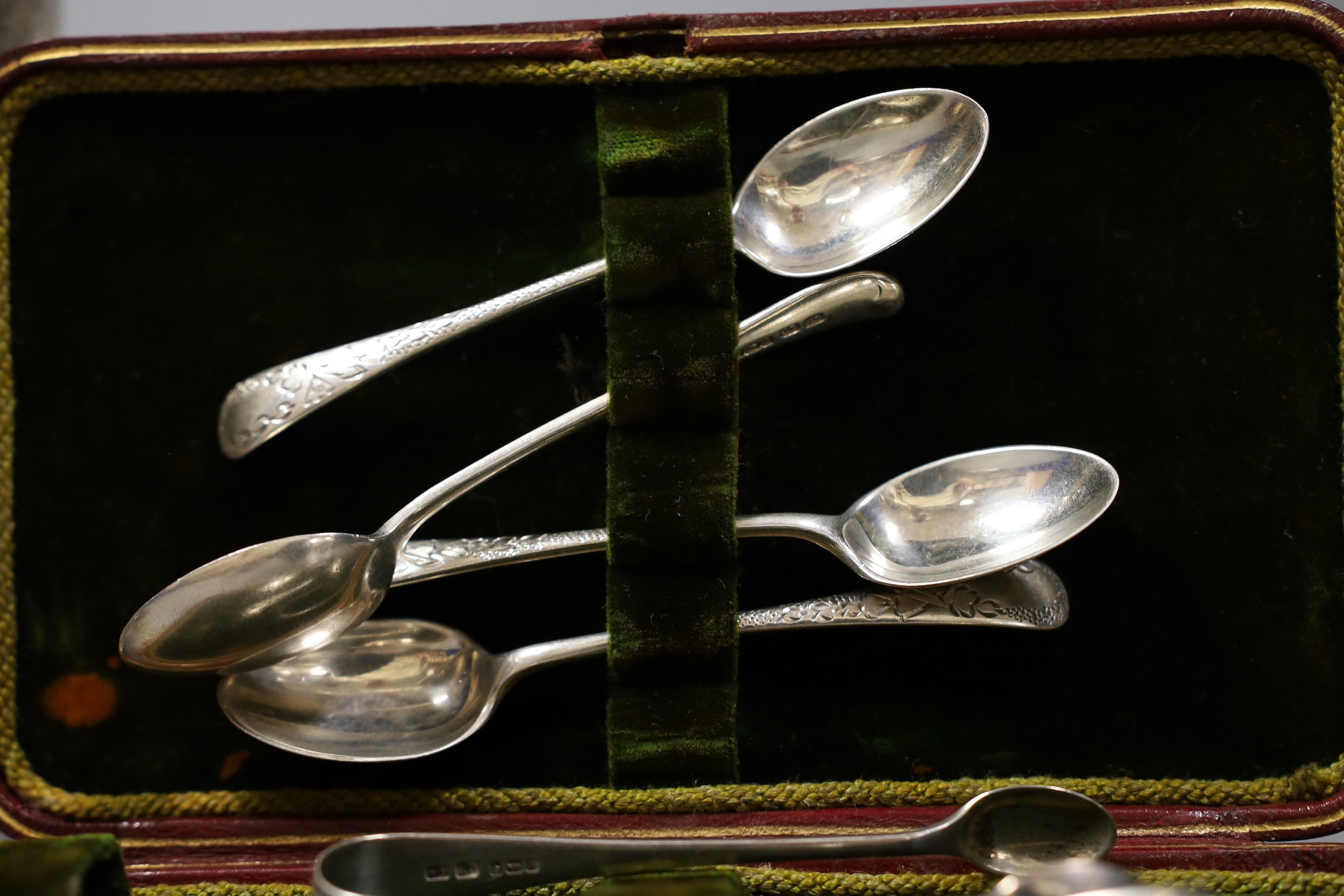 A set of six George V silver teaspoons and tongs, 3oz, a cased pair of Victorian silver gilt apostle serving spoons, 2.9oz and an incomplete plated egg coddler